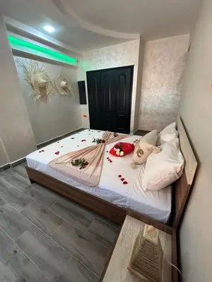 a bedroom with a large bed with flowers on it at Appartement 3 chambres Gueliz Hivernage Marrakech centre 5 Etage M21 in Marrakech