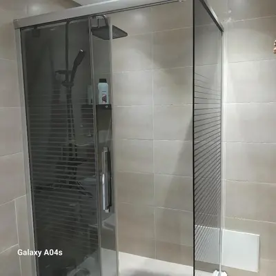 a shower with a glass door in a bathroom at Appartement Familial à Marrakech avec des espaces verts et 5 piscines in Marrakech