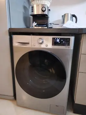 a washing machine in a kitchen with a counter at Appartement Familial à Marrakech avec des espaces verts et 5 piscines in Marrakech