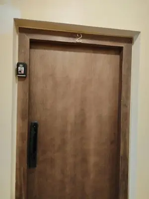 a wooden door with a handle in a room at Appartement Familial à Marrakech avec des espaces verts et 5 piscines in Marrakech