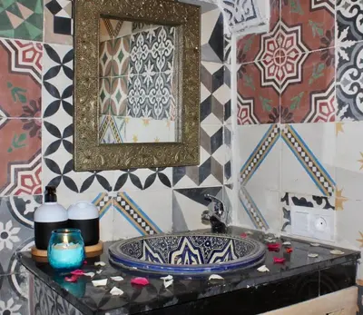 a bathroom with a sink and a mirror at La Maison Berber Shams in Marrakech