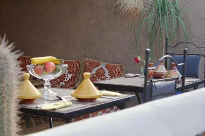 a table with a bowl of fruit on top at La Maison Berber Shams in Marrakech