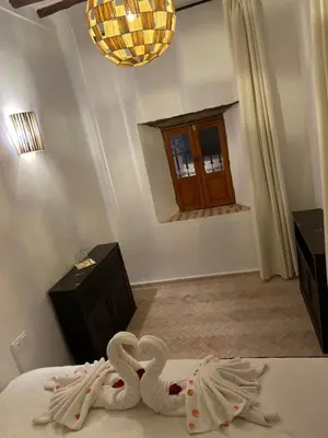 a bedroom with two swans made out of towels at La Maison Berber Shams in Marrakech