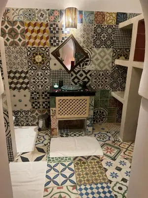 a room with a bunch of tiles on the wall at La Maison Berber Shams in Marrakech
