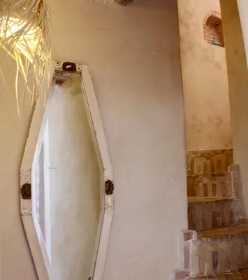 a wall with a door in the corner of a room at La Maison Berber Shams in Marrakech