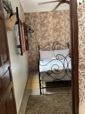 a bedroom with a bed in a room at DAR SI AHMED Riad Typique avec Terrasse Panoramique et Vue Exceptionnelle in Marrakech