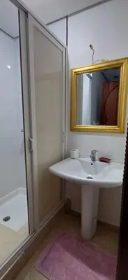 a bathroom with a sink and a mirror and a shower at Résidence hamza appartement 2 chambre in Marrakech