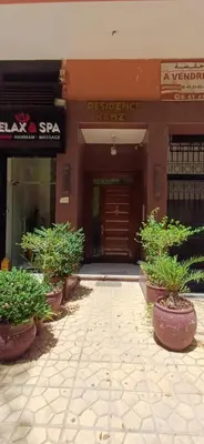 a building with potted plants in front of it at Résidence hamza appartement 2 chambre in Marrakech