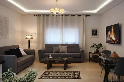 a living room with a couch and a table at Luxury Apartment in Hivernage Marrakech in Marrakech