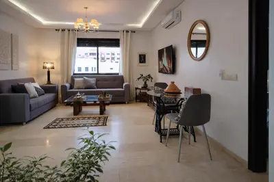 a living room with a couch and a table at Luxury Apartment in Hivernage Marrakech in Marrakech