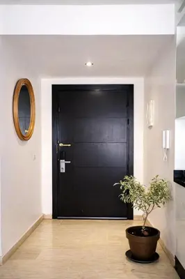 a black door with a potted plant in front of it at Luxury Apartment in Hivernage Marrakech in Marrakech
