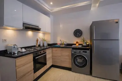 a kitchen with a stainless steel refrigerator and a dishwasher at Luxury Apartment in Hivernage Marrakech in Marrakech