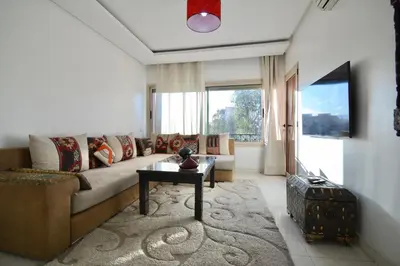 a living room with a couch and a table at Appart charmante au cour de marrakech l'hivernage in Marrakech