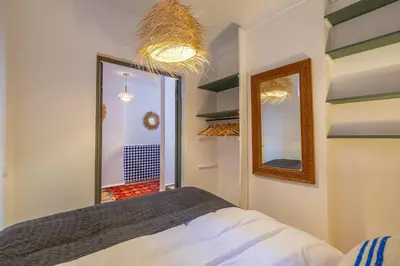 a bedroom with a bed and a mirror on the wall at Riad YANNIS in Marrakech