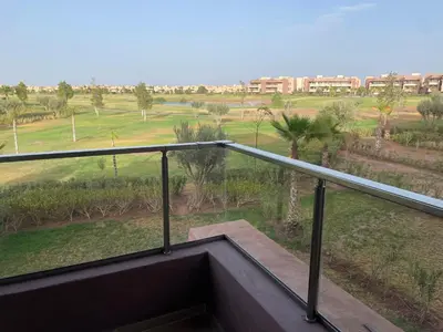 a balcony with a view of a field at Appartement luxueux à Prestigia SAPHIR in Marrakech