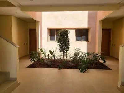a hallway of a building with a bunch of plants at Appartement luxueux à Prestigia SAPHIR in Marrakech