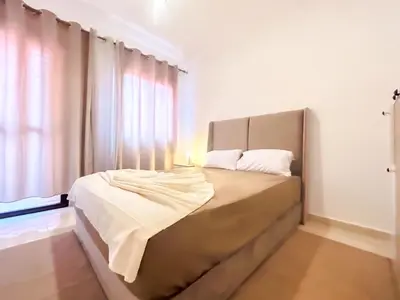 a bed in a room with a window at L'Havre de Paix - Proxi Centre - 2 Chambres in Marrakech