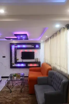 a living room with a couch and a tv at medina View Apartment in Marrakech
