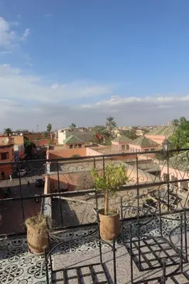 a balcony with two potted plants and a view of a city at medina View Apartment in Marrakech