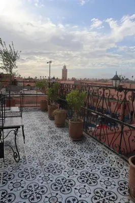 a balcony with potted plants and a view of a city at medina View Apartment in Marrakech