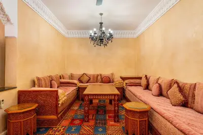 a living room with a couch and a table at Charmant Riad privatif au cœur de la Médina in Marrakech