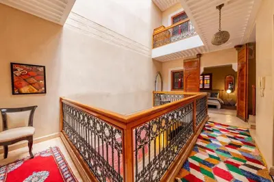 a room with a wooden staircase with a rug at Charmant Riad privatif au cœur de la Médina in Marrakech
