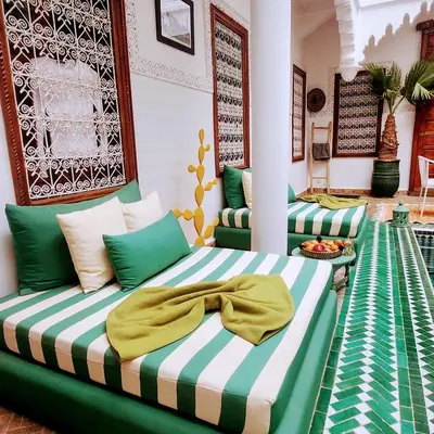 a room with two beds with green and white at Riad Vilamoura & SPA in Marrakech