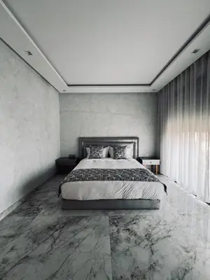 a bedroom with a large bed with marble floors at Dream villa in Marrakech
