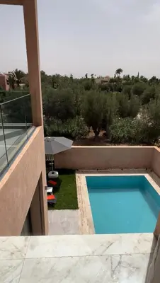 a swimming pool on the side of a house at Dream villa in Marrakech