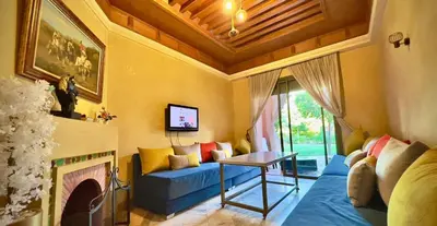 a living room with a blue couch and a fireplace at Palmeraie vue piscine 3 in Marrakech
