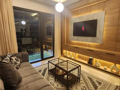 a living room with a couch and a flat screen tv at Firstwood Chic Apartment Hivernage in Marrakech