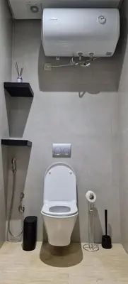 a bathroom with a white toilet and a tank at Firstwood Chic Apartment Hivernage in Marrakech