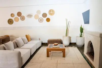 a living room with a white couch and a fireplace at Riad Tamazigh in Marrakech