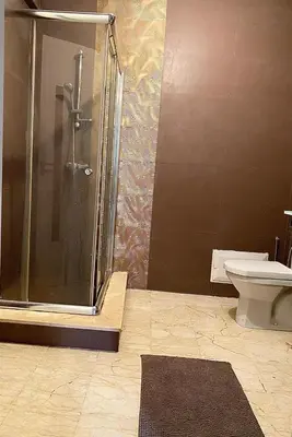 a bathroom with a shower and a toilet at Apparemment 1 chambre salon à coté de la gare guéliz 20 in Marrakech