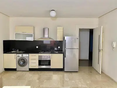 a kitchen with a refrigerator and a stove at Apparemment 1 chambre salon à coté de la gare guéliz 20 in Marrakech