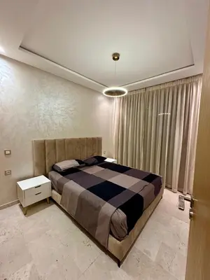 a bedroom with a large bed in a room at Appartement 2 chambres salon à coté de carré éden Perles3 in Marrakech