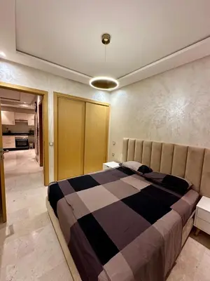 a bedroom with a large bed in a room at Appartement 2 chambres salon à coté de carré éden Perles3 in Marrakech