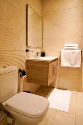 a bathroom with a white toilet and a sink at Appartement 2 chambres salon à coté de carré éden Perles3 in Marrakech