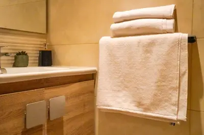 a bathroom with a sink and towels on a towel rack at Appartement 2 chambres salon à coté de carré éden Perles3 in Marrakech