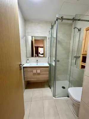 a bathroom with a shower and a sink and a toilet at Appartement 2 chambres salon à coté de carré éden 10 in Marrakech