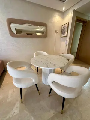 a table and chairs in a room with a table at Appartement 2 chambres salon à coté de carré éden 10 in Marrakech