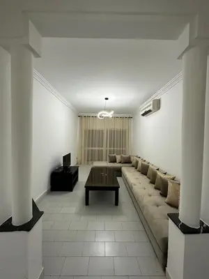 a large living room with a couch and a table at Appartement 3 chambres salon à coté de éden et Mcdo 6 in Marrakech
