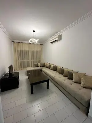 a living room with a couch and a coffee table at Appartement 3 chambres salon à coté de éden et Mcdo 6 in Marrakech