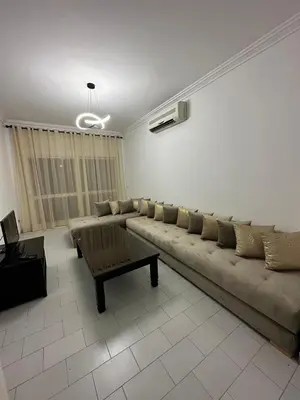 a living room with a couch and a coffee table at Appartement 3 chambres salon à coté de éden et Mcdo 6 in Marrakech