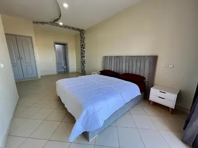 a bedroom with a bed with a blue comforter at Appartement 2 chambres salon à coté de la gare centre de guéliz 21 in Marrakech