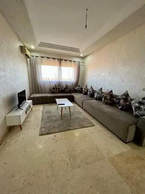 a living room with a couch and a table at Appartement 2 chambres salon à coté de la gare centre de guéliz 21 in Marrakech