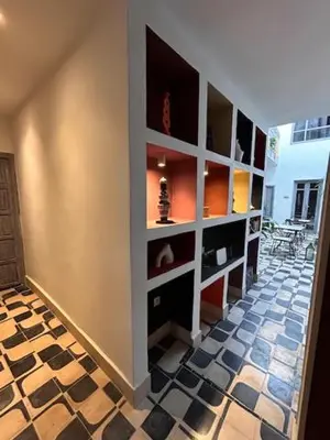 a room with a wall with shelves and a tile floor at Riad Be Colors in Marrakech