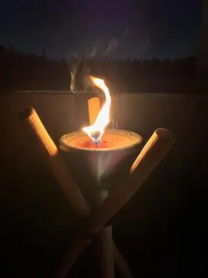 a candle with a fire in the dark at Riad Be Colors in Marrakech