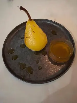 a yellow pear sitting on top of a plate at Riad Be Colors in Marrakech