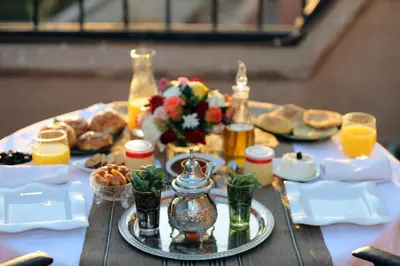 a table with breakfast foods and drinks on it at The Little Hara in Marrakech